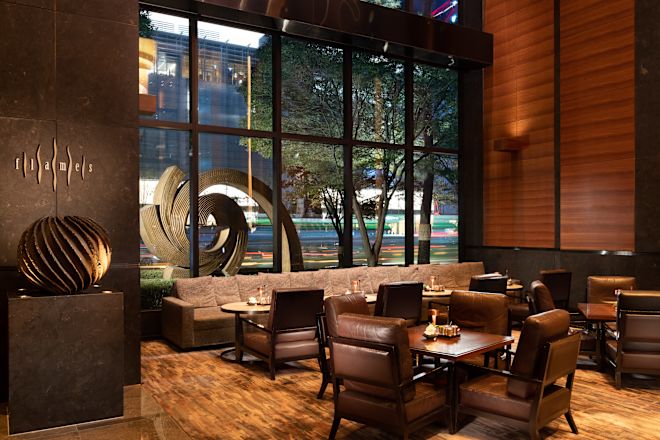 Interior of Flames. Floor to ceiling windows look out into the night sky.