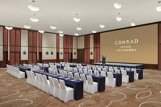 Ballroom with tables, chairs and projector screen