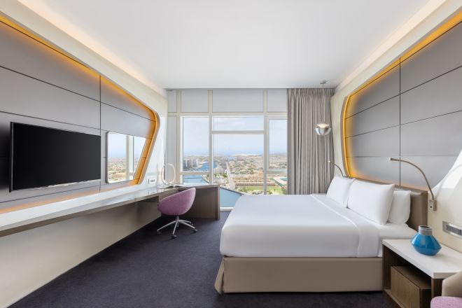 Large Bed in a Guest Room with Desk, HDTV and Canal View