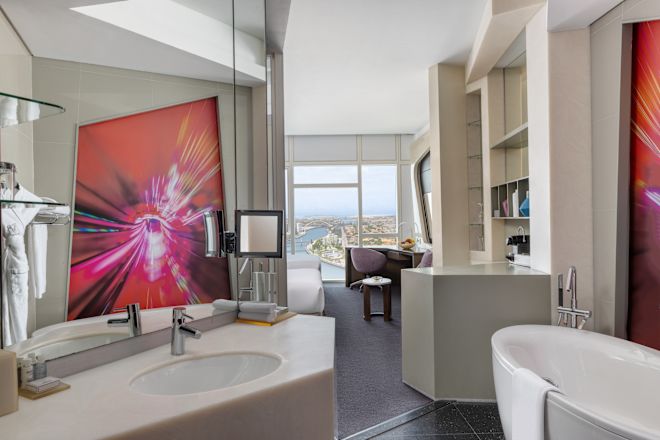 Vanity Area, Tub, and Separate Bedroom in a Guest Room with Canal View