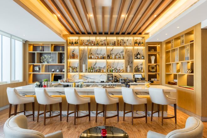 Bar in the Lounge with seating at bar and table and chairs.