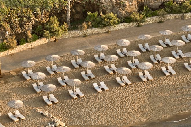 Lounge Chairs under Umbrellas on a Private Beach
