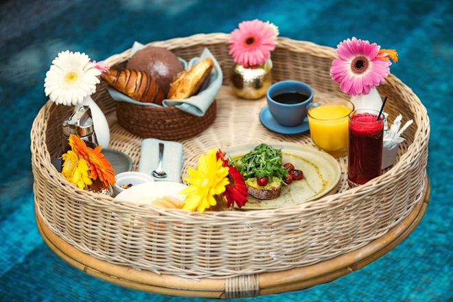a Basket with Food and Flowers at Oliva by Daniel Ovadia Restaurant