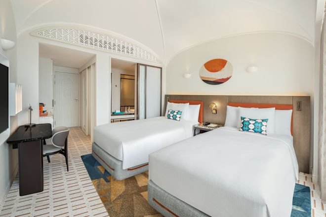 ベッド2台、ハイビジョンテレビ、ワークデスクを備えた客室