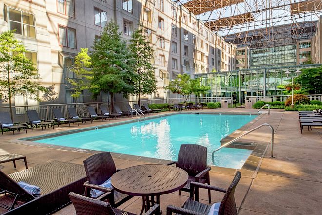 Outdoor Swimming Pool in Courtyard Area with Tables and Chairs