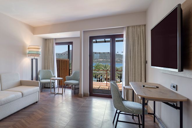 Guestroom lounge area with couch and TV