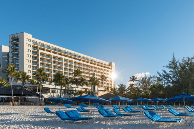 Lounge Chairs at the Beach and View of Hilton Hotel Exterior