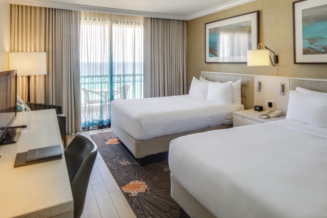Premium Ocean View Guestroom with Double Beds, Lounge Area, Work Desk, and Room Technology