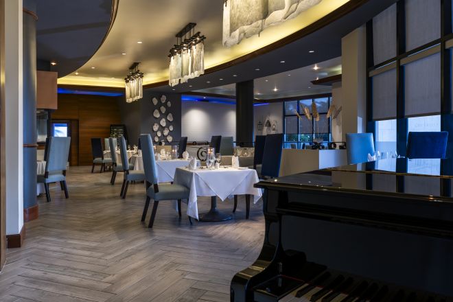 Piano and Dining Area of The Grille Bajan Inspired