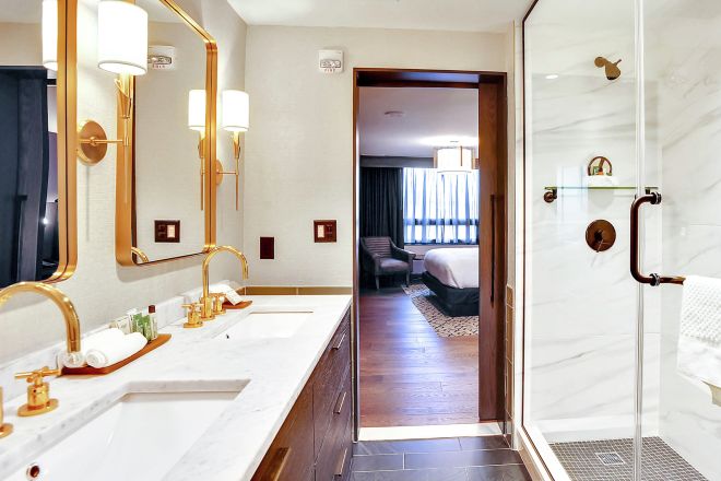 Chief of State Guest Bathroom with Dual Vanity Area and Shower with Sliding Glass Doors