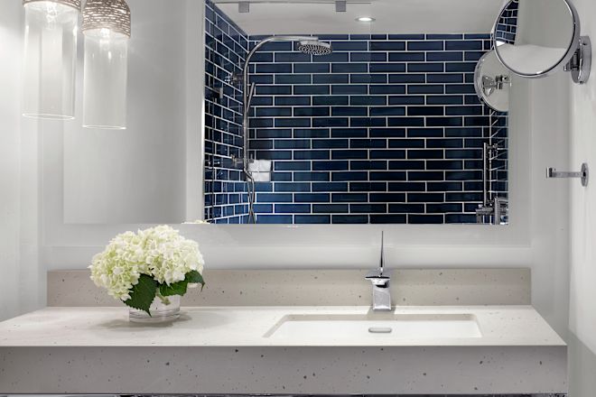 Bathroom Vanity Area with View of Shower Reflected in Mirror