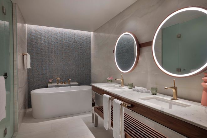 バスルームを備えたブライダルスイートのシンクエリアとバスタブ