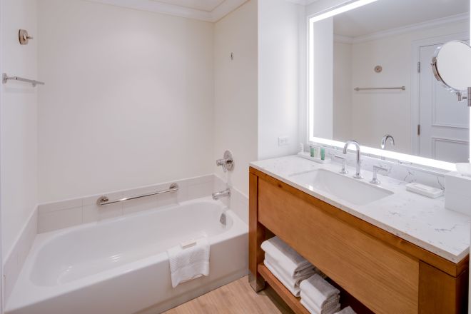 Vanity Mirror and Tub in Bathroom with towels
