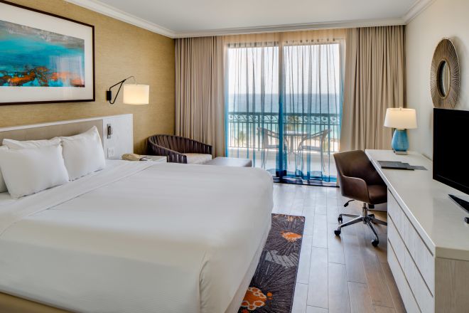 King bed with lounge chair, work desk, and TV