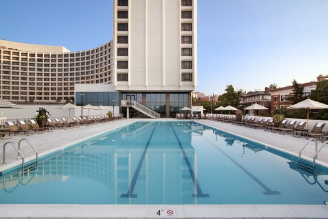 Shot of pool with hotel behind