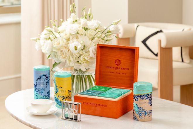 Table tea setup with white flowers behind them