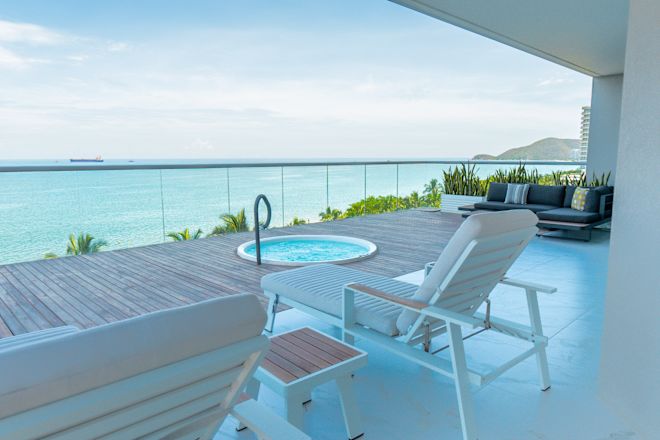 outside sitting area with whirlpool, sofa, loungers