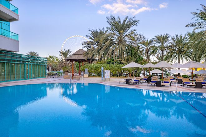 Outdoor Pool with Lounge Chairs under Umbrellas