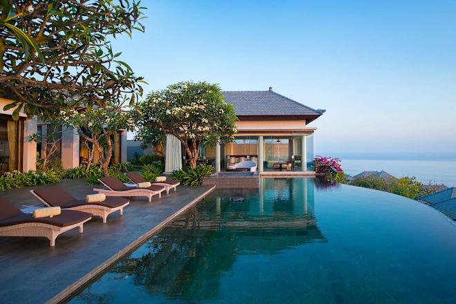 Exterior of guest room, with loungers and pool area