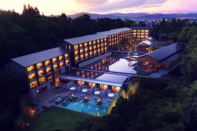 Hotel exterior at dusk with pools