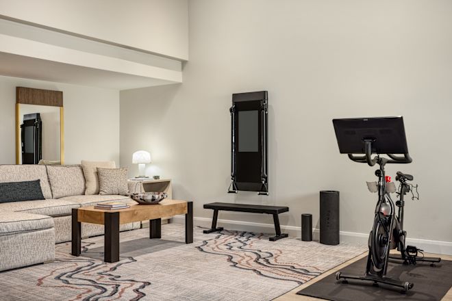 Guest villa living area with sofa, coffee table, and workout bike