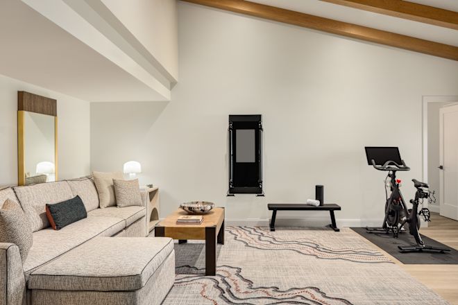 Guest villa living room area with couch and fitness bike