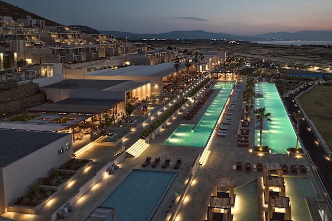 aerial view of hotel and outdoor pools at dusk