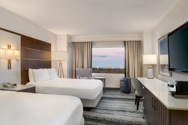 Guest Room with Two Queen Beds, TV, Work Desk, and Outside View