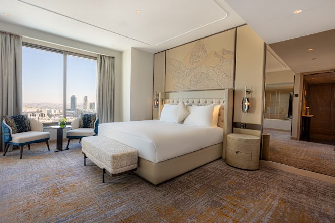 King Club Signia Ambassador Suite Bedroom with Lounge Chair