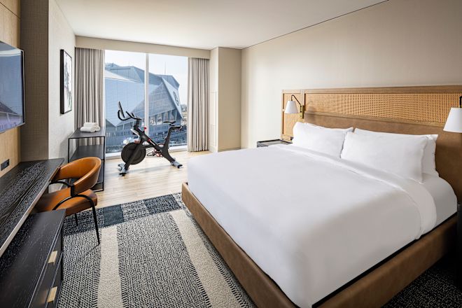 Guestroom with bed, peloton bike and TV