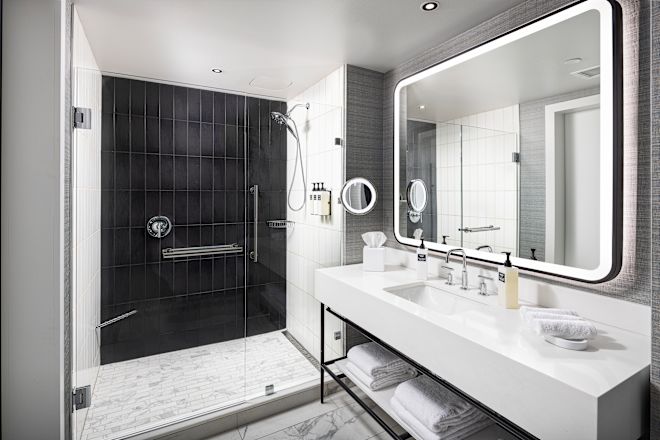 Guestroom bathroom with shower and vanity area