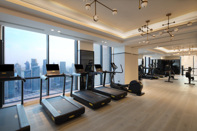 Treadmills in a Fitness Center with City View from Large Windows