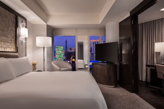 king bedroom with night view of strip