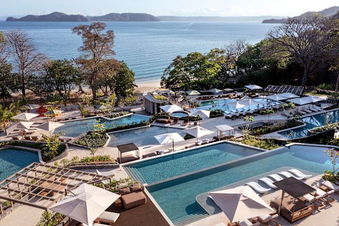 View of Outdoor Pools and Beach in Background