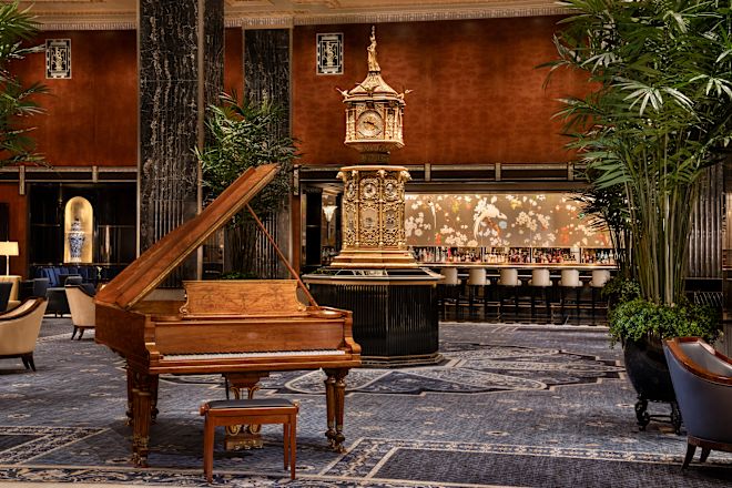Luxurious lobby with piano, clock and bar area