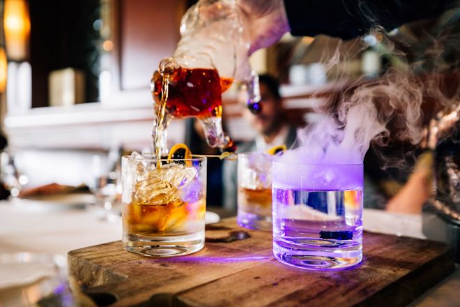 Bull & Bear restaurant, bartender pouring a drink with bull pitcher