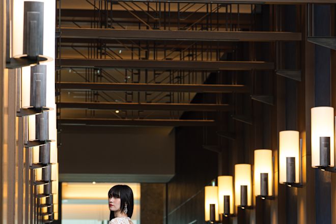 Bride in a modern wedding gown looking over her shoulder.
