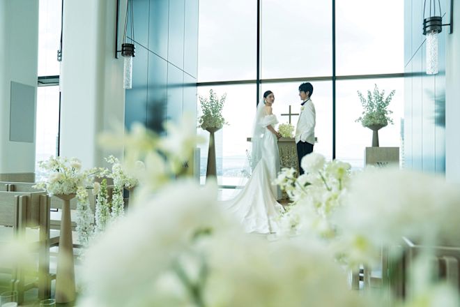 Bride and groom standing at the front of the chapel.