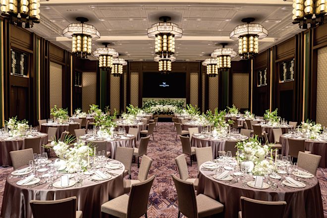 Venue with round tables decorated, and set up for reception dinner.