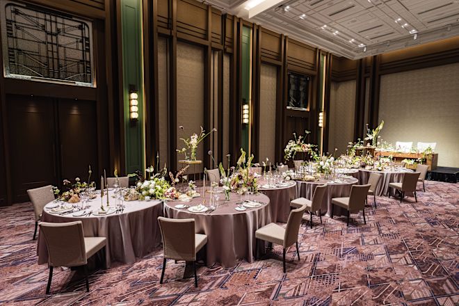 Venue with round tables decorated, and set up for reception dinner.