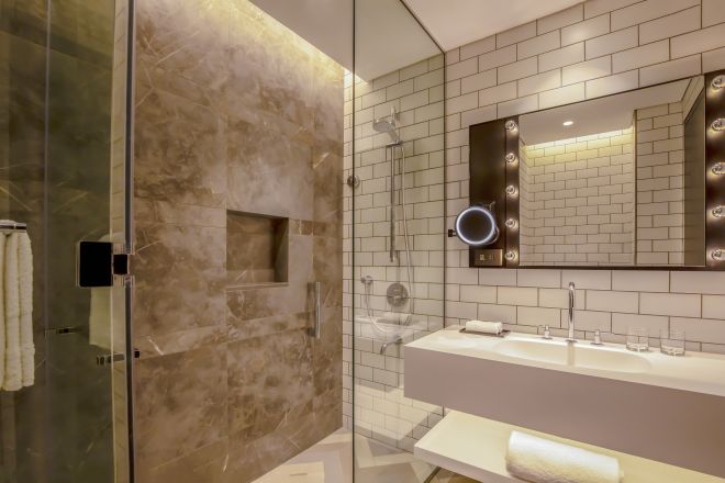 Bathroom with shower and vanity mirror
