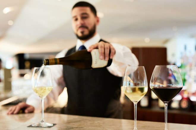 Happy Hour at ATRIO Wine Bar & Restaurant, Bartender pouring wine