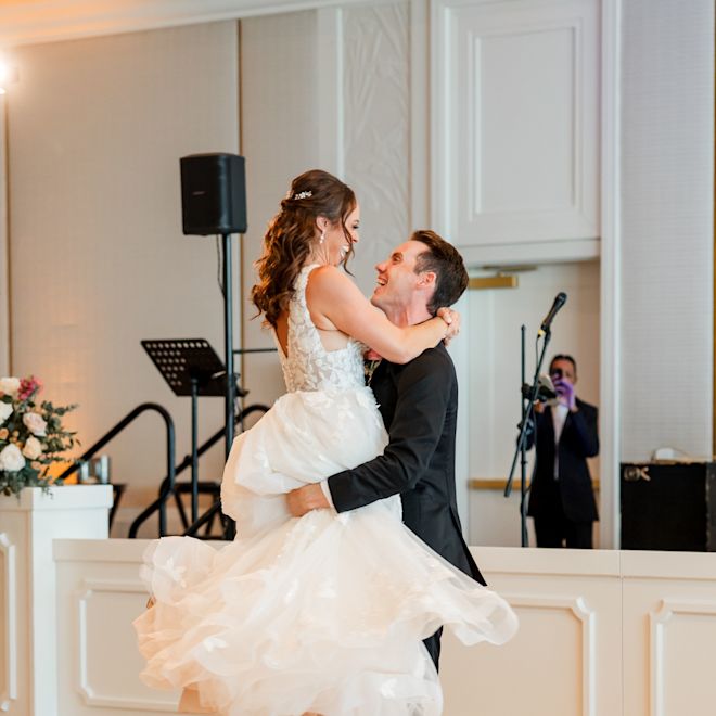 Bride and Groom Dancing  in a Ballroom on Their Wedding Day