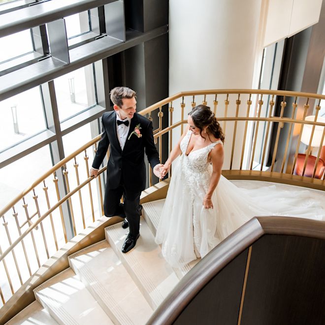 Bride and Groom Walking Downstairs to the Lobby on Their Wedding Day