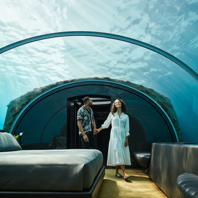 Man and woman in underwater bedroom