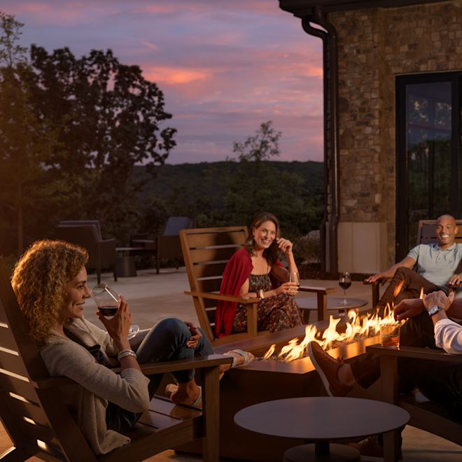 A group of sitting around outdoor Firepit