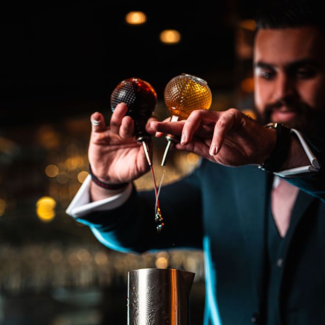 The Caley Bar Bartender Mixing Drink