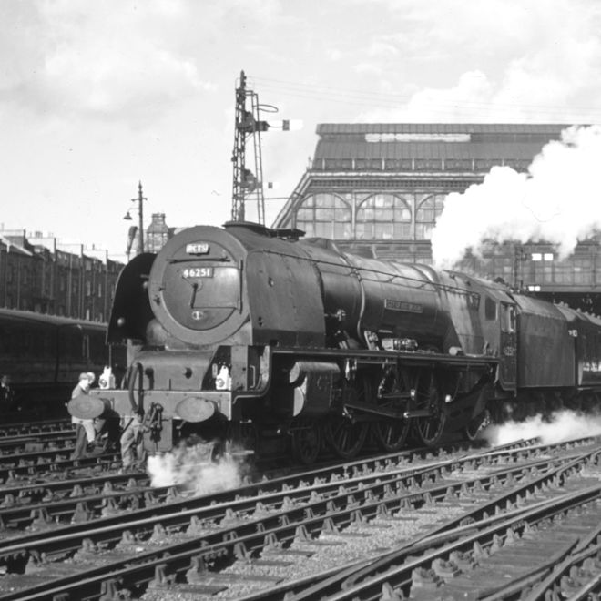 Old shot of train pulling out of station