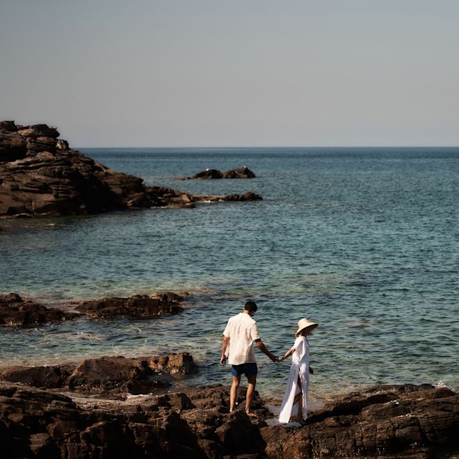 Couple Walking on Rocks at the Beach