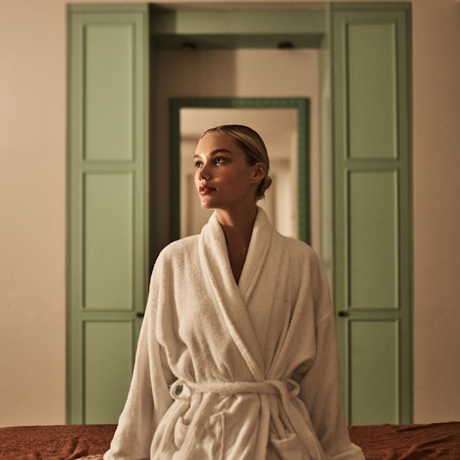 Woman Wearing a White Robe, Getting a Massage at the Spa